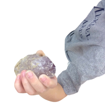 Childs Hand Holding Up A Amethyst Crystal